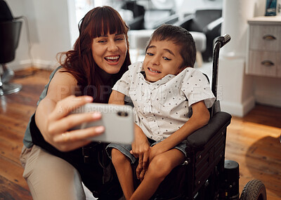 Buy stock photo Child, cerebral palsy and happy phone selfie of a mobile disability boy in a wheelchair. Woman or mother smile with a young kid using technology to take a picture together with happiness and care 