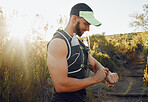 Man, nature and hiking with time on smartwatch in sunshine for run, hike or race. Runner, fitness and trail for health, wellness and workout on sport adventure during summer with tech, gps or clock