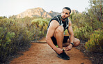 Fitness, nature and man tie shoes before start of marathon training, exercise or health workout in USA Hollywood Hills. Sports, dirt path and runner ready for peace, freedom or wellness cardio run