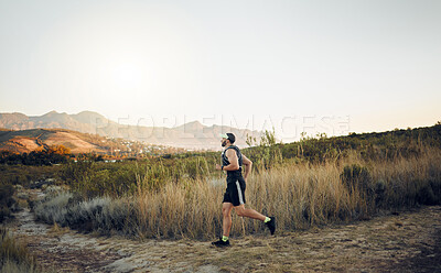 Man running in nature, marathon fitness training exercise and healthy sunrise cardio workout. Sports runner, racing on hiking path and working out to for athletic speed or energy in race competition