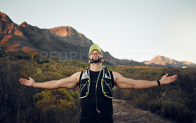 Fitness, achievement and winner of a man in nature embracing freedom, victory and success in the outdoors. Active male in sports adventure, exercise and workout for healthy wellness and fresh air