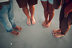 Friends, feet and beach in water, sand and travel summer vacation with diversity, men and women. People relax on tropical sea holiday with wet toes together while traveling, friendship and trip