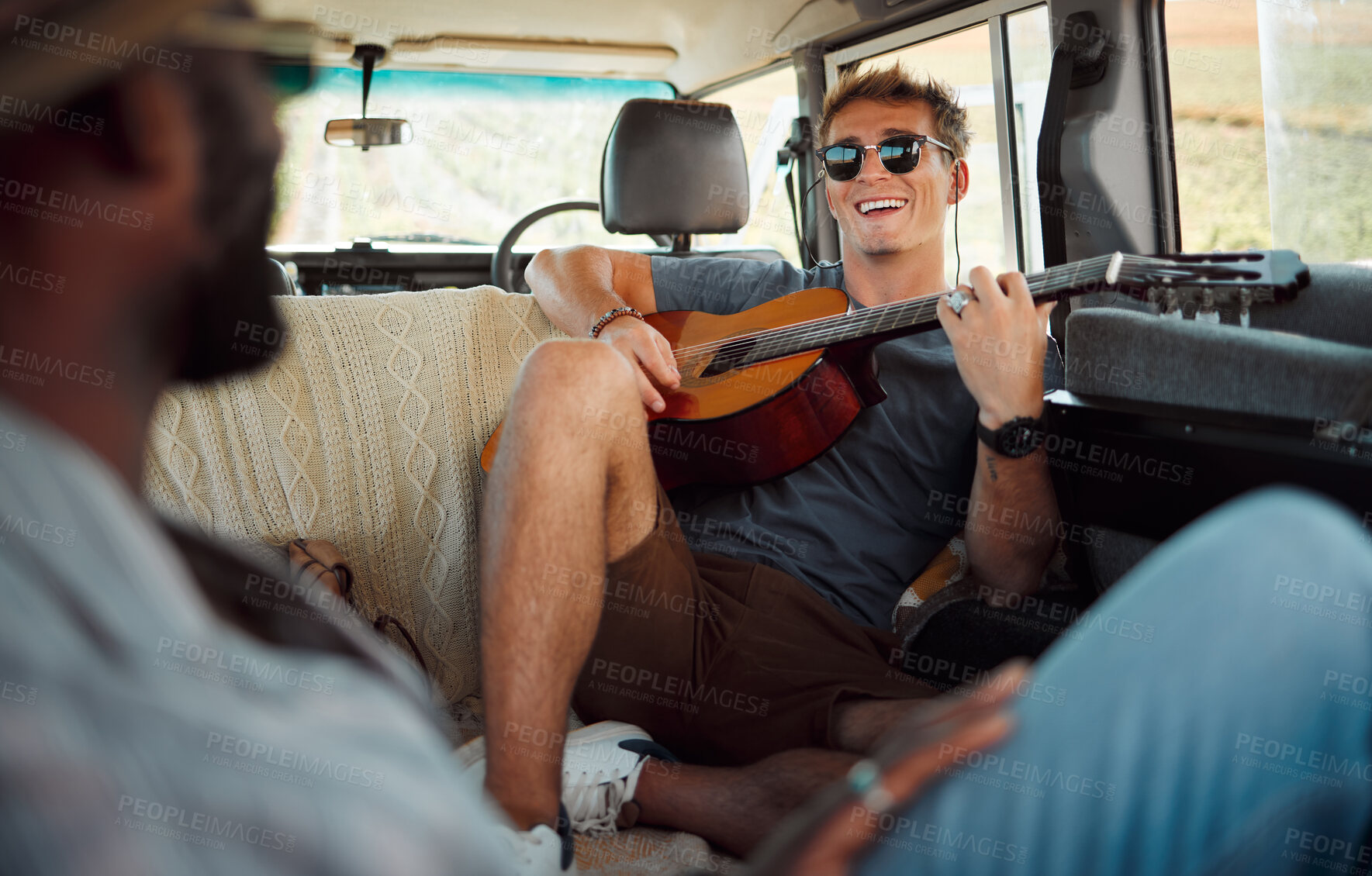 Buy stock photo Man with guitar, music in van and smile on travel vacation road trip together with friends. Group holiday in summer, relax and happy musician singing with instrument on a countryside safari adventure