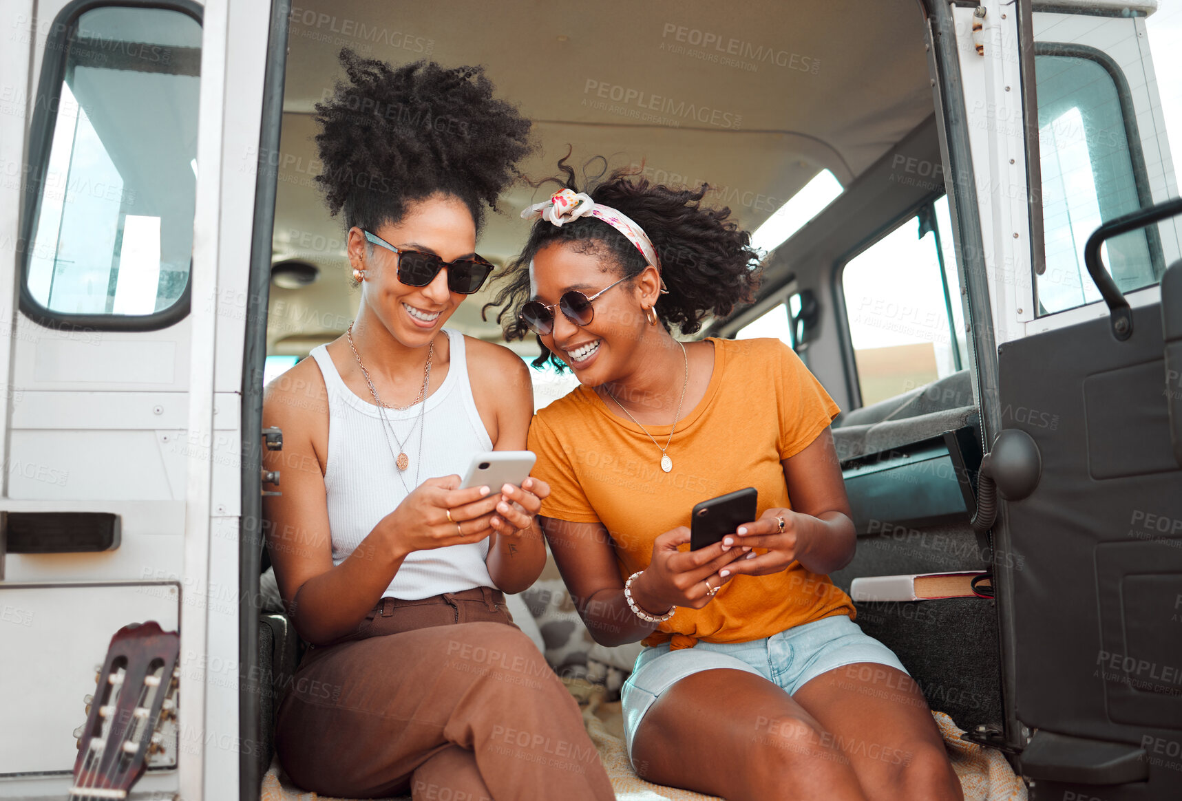 Buy stock photo Women, road trip or phone for social media, gps location or map app for safari game drive or summer travel. Smile, happy or bonding friends with 5g mobile technology in camper van in nature landscape