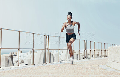 Buy stock photo Running, black woman and beach marathon training, fitness and wellness for sports goals, body motivation and energy outdoors. Focus, speed and cardio runner athlete, ocean exercise and summer workout