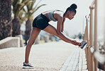 Fitness, running and black woman stretching legs outdoors to start marathon training, cardio exercise or urban city sports workout in Brazil. Strong, focus and runner athlete warm up of body wellness