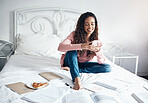 Books, bed and woman with a phone reading social media and internet posts on break from studying in a bedroom. Student, learning and relax by black woman browsing online for idea for creative writing
