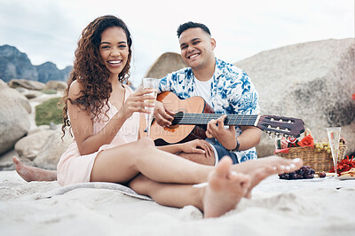 Buy stock photo Couple, beach and guitar for music and love on picnic together on sand by ocean. Man, woman and smile with happiness on face with food, champagne and flowers to relax, vacation and travel in summer