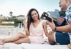 Happy couple, guitar and love on a beach together playing a romantic, love or affection music for woman. Portrait romance, happy young man and woman play string instrument and laugh outdoor on sand
