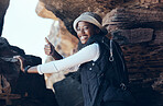 Woman, thumbs up and hiking success in mountains cave, countryside environment or remote Namibia landscape. Portrait, smile and motivation fitness hiker in nature exercise, training or health workout