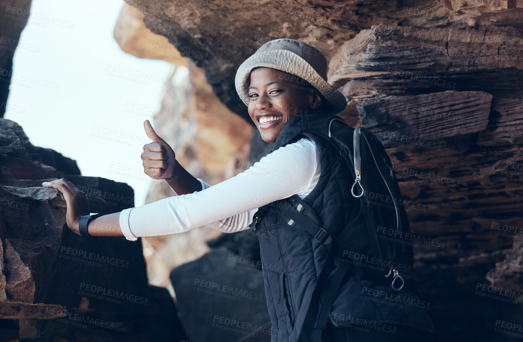 Buy stock photo Woman, thumbs up and hiking success in mountains cave, countryside environment or remote Namibia landscape. Portrait, smile and motivation fitness hiker in nature exercise, training or health workout