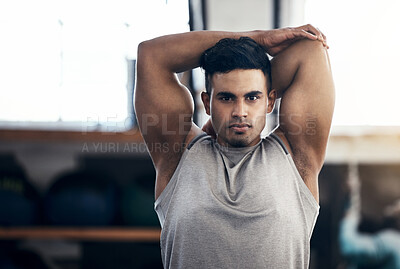 Buy stock photo Health, young man stretching and wellness training in gym for workout, fitness and cardio. Portrait, Indian male or athlete confident, bodybuilding or doing healthy warm up for exercise in sportswear
