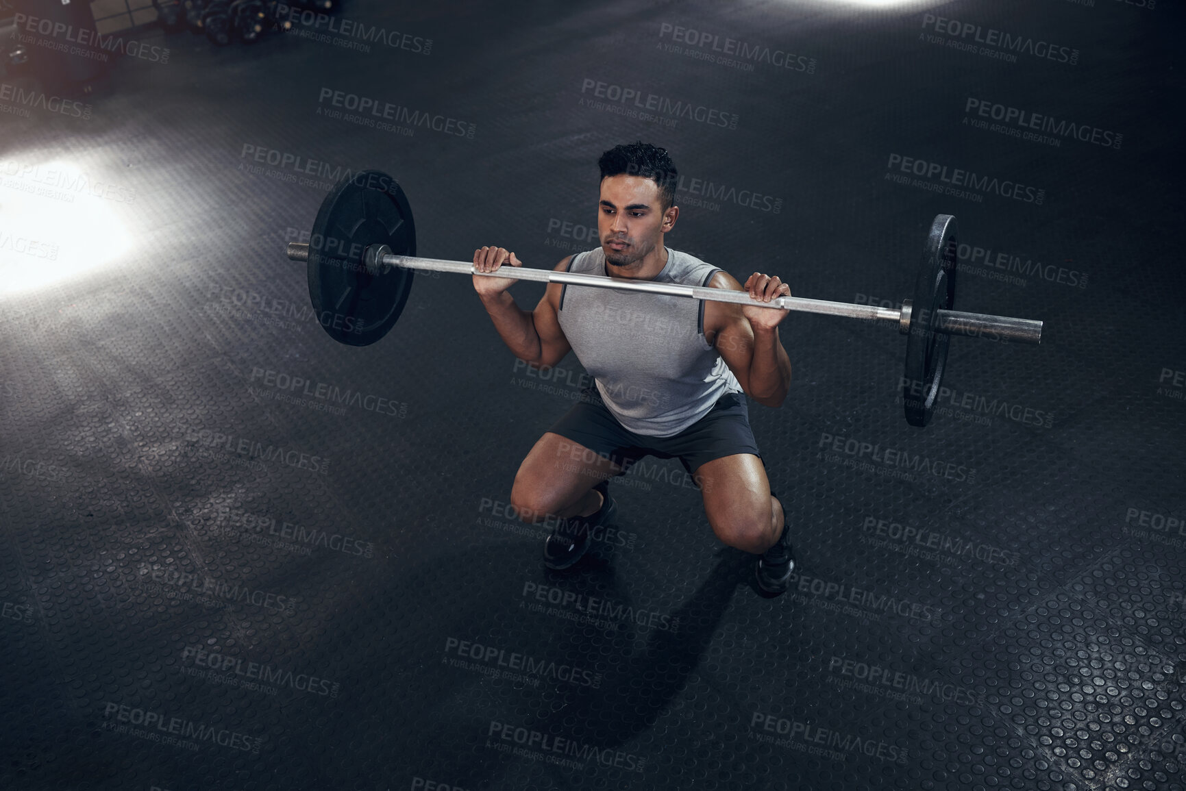 Buy stock photo Barbell exercise, gym man and sports training, workout and fitness of heavy weights press in health club. Above of indian bodybuilder, serious male athlete and body muscle, power or strong motivation