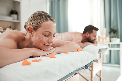 Buy stock photo Spa, massage and couple relax in luxury treatment for health, wellness and therapy session at a resort. Man and woman enjoying a calm day of zen, care and relaxation lying on a table for vacation