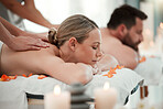 Couple, spa massage or relax wellness in peace, healthcare or reiki hotel salon in self care, muscle tension or stress. Masseuse hands, woman or man on luxury honeymoon table bed in zen pamper space 