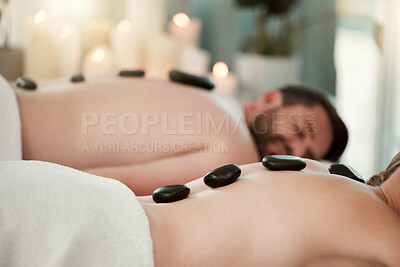 Hot stone, relax and couple with massage at spa for wellness, relax and skin therapy on holiday at a hotel. Man and woman sleeping during luxury natural cosmetics for skin and body health on vacation
