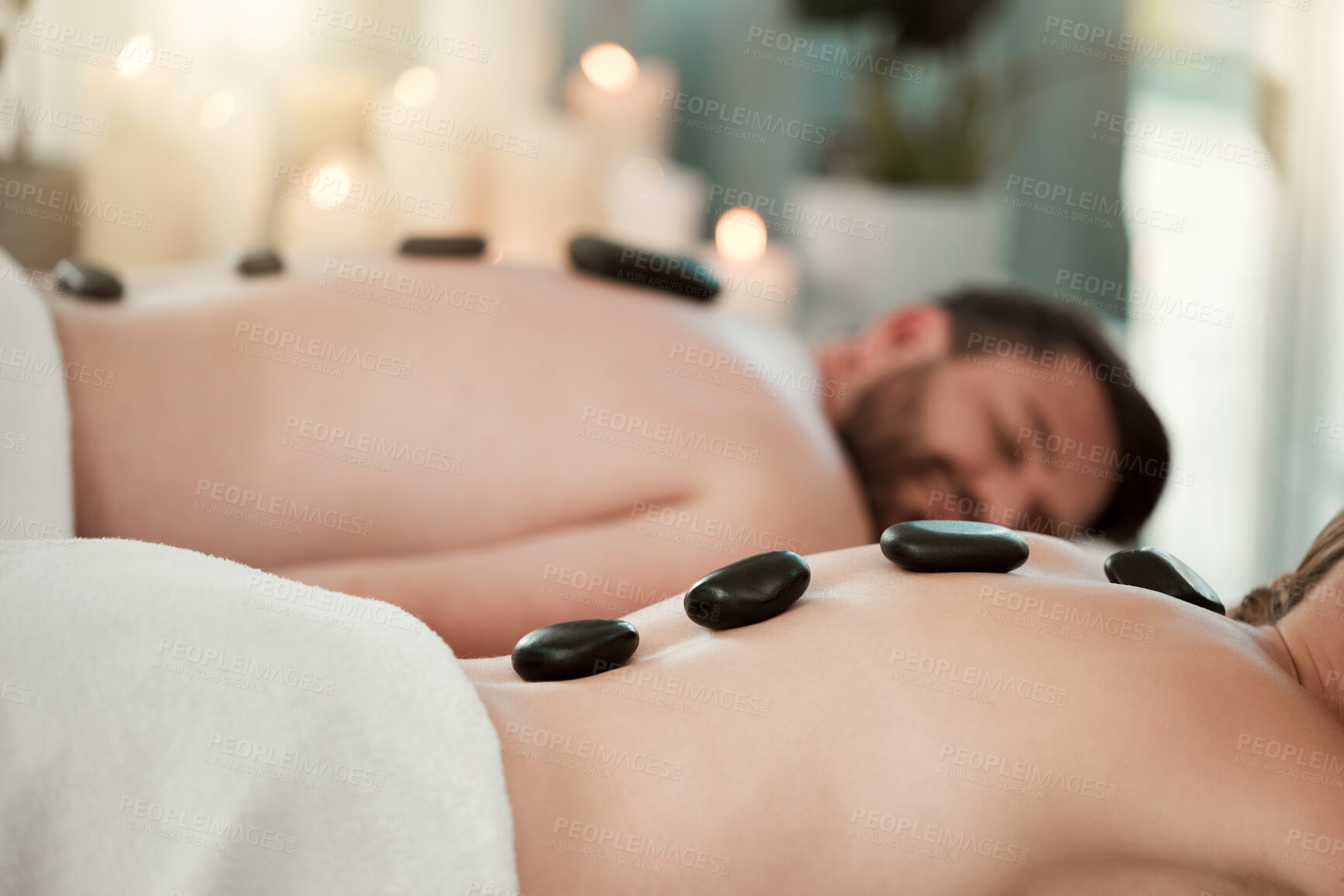 Buy stock photo Hot stone, relax and couple with massage at spa for wellness, relax and skin therapy on holiday at a hotel. Man and woman sleeping during luxury natural cosmetics for skin and body health on vacation