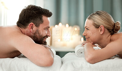 Buy stock photo Couple, spa and luxury massage together for healthy, relax and wellness at a holiday resort. Happy man and woman in relationship looking at each other in massaging therapy for calm relaxation