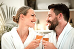 Spa couple, wine glass toast and celebration of love, relax and wellness luxury hotel on vacation together. Smile man, happy woman and champagne drink cheers at body massage salon to celebrate date