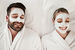 Skincare, spa and face mask with relax couple smile, happy and luxury cosmetic treatment together. from above. Man and woman skincare, beauty and wellness at a health clinic for relaxation body care