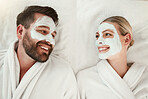 Love, face mask and skincare couple relax, body care and  in gowns on spa vacation celebrate anniversary, honeymoon or relationship. Man and woman on holiday smile together, on retreat and bonding.