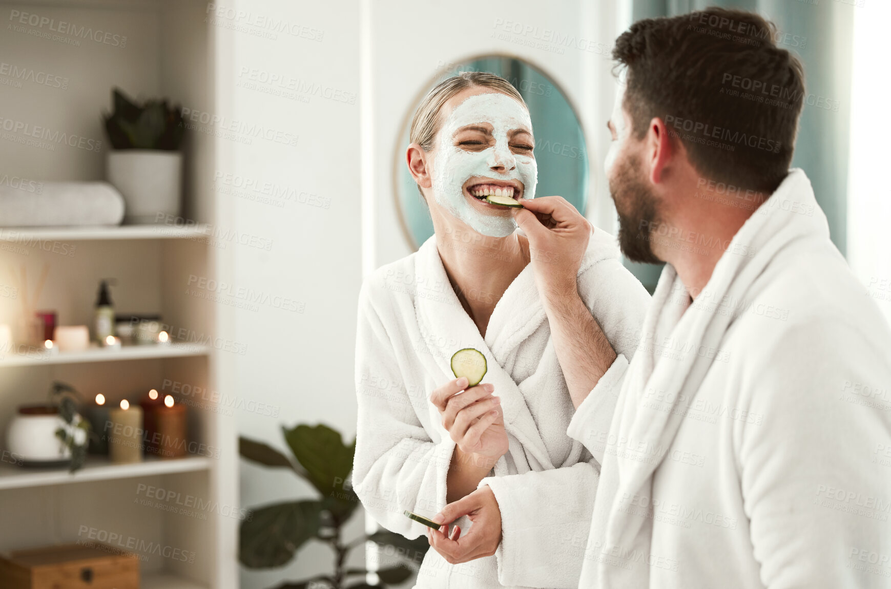 Buy stock photo Happy couple playful, facial and relax at spa for wellness, skincare, love together and eating cucumber. Healthy fun relationship, luxury body care for calm, therapy and zen at health salon. 