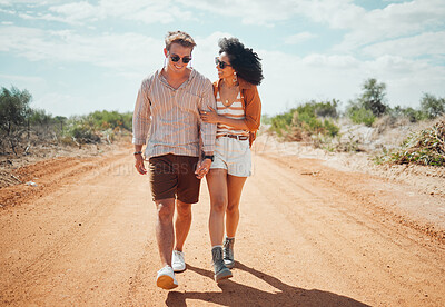 Buy stock photo Couple, sunglasses and walking on dirt road in nature on holiday, vacation or summer safari trip. Diversity, love and man, woman and travel outdoors, talking and bonding or spending time together.