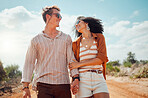 Safari, walking and couple holding hands on a holiday in the desert during summer in Africa. Happy, smile and travel man and woman on walk for adventure during vacation in the desert in nature