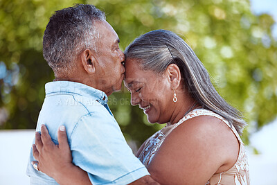 Buy stock photo Elderly, couple and happy with love, hug and kiss on face in backyard, garden or park together in summer. Man, woman and retirement show romance, bonding and care in nature, smile and embrace