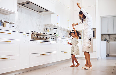 Buy stock photo Dance, playful child and mother being comic, crazy and free with a girl in the kitchen together at home. Care, love and happy kid dancing with her mom in freedom while listening to music in house