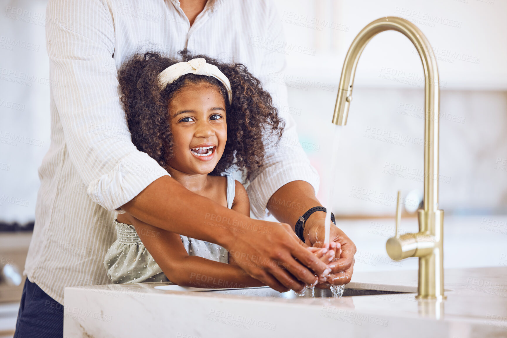 Buy stock photo Portrait of a family washing their hands for hygiene, to stop germs and health in the kitchen at home. Happy, smile and father helping his child clean her hand of bacteria, dirt and dust in a house.