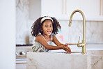 Clean, smile and African child washing hands with water by the tap in the kitchen in a house. Happy portrait of a girl kid cleaning her hand with liquid for health and safety from virus in her home