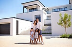 Portrait, real estate and happy family moving into their new luxury home, house or property in summer. Happy parents and children standing with a smile outdoor with building investment or purchase
