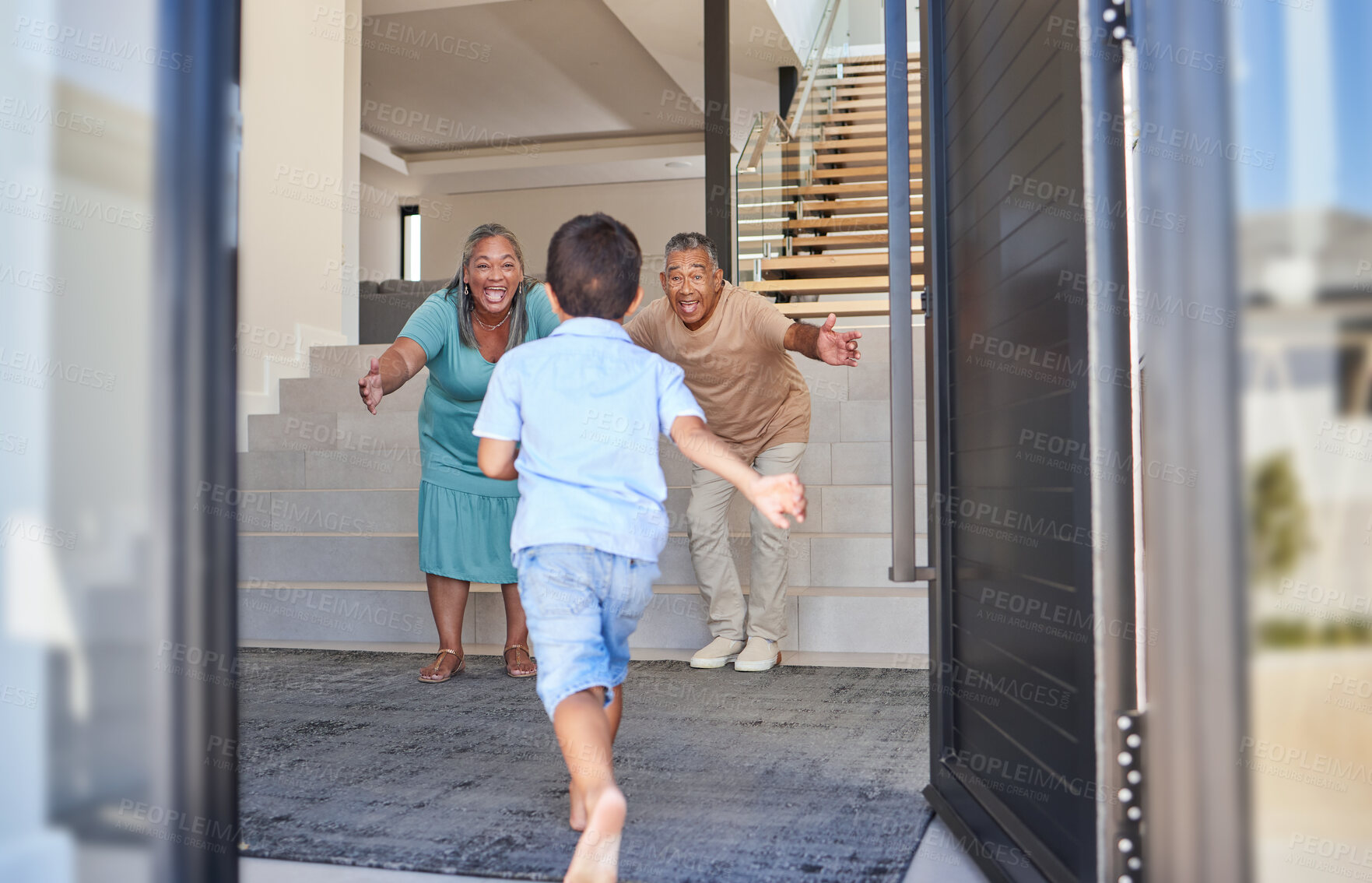 Buy stock photo Excited kid running to grandparents in family home meeting, greeting and hugging with love, care and happiness. Elderly man, senior woman and happy people welcome grandson child at front door house