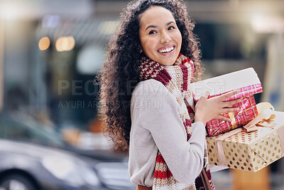 Buy stock photo Shopping, christmas and retail with a black woman customer holding a gift or present outdoor in the city. Celebration, holiday and happy with a young female consumer at an outdoor mall or store