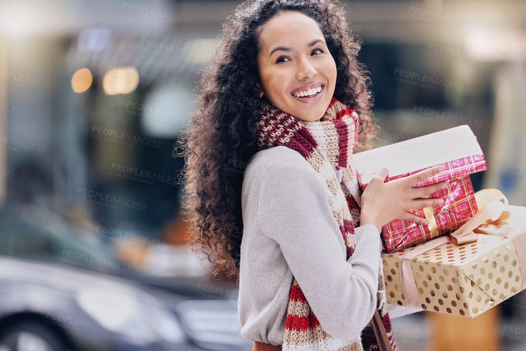 Buy stock photo Shopping, christmas and retail with a black woman customer holding a gift or present outdoor in the city. Celebration, holiday and happy with a young female consumer at an outdoor mall or store