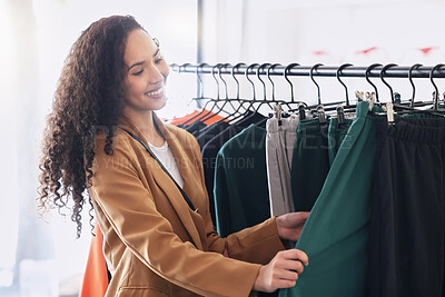 Buy stock photo Retail, happy and woman with choice while shopping in a fashion boutique during a sale on clothes. Young black woman and customer withh smile in a store or shop for designer clothing on discount