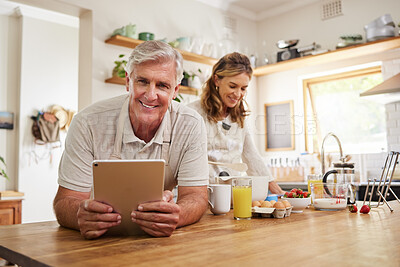 Buy stock photo Portrait, senior couple and cooking with tablet together in a modern kitchen of the home. Happy, retirement and elderly man and woman baking with ingredients, recipe and instructions on mobile device