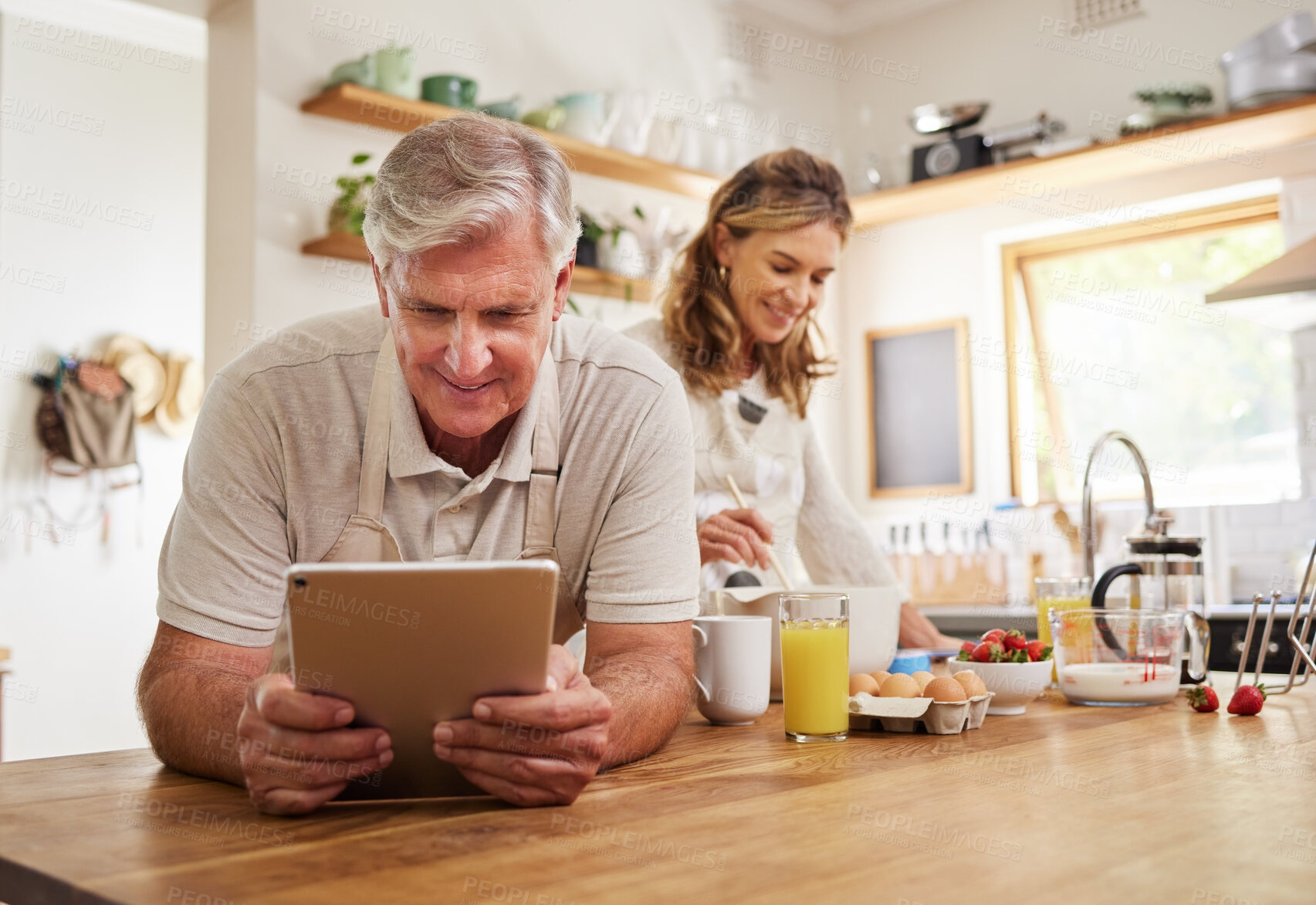 Buy stock photo Cooking, tablet and food with old couple in kitchen in the morning for breakfast, health and internet recipe together. Happy, digital and retirement with senior man and woman baking for diet at home