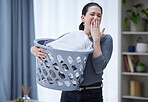Tired, yawning and woman with laundry basket in home feeling stress, burnout and fatigue from spring cleaning, washing clothes and chores. Exhausted sleepy female covering mouth from bored housework