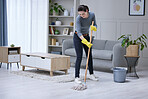 Mopping, floor and woman cleaning the living room of her house. Cleaner or professional worker with apartment service working in housekeeping, care for home and safety from virus with disinfection