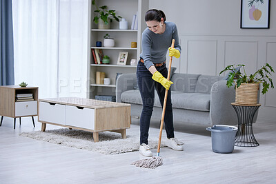 Buy stock photo Mopping, floor and woman cleaning the living room of her house. Cleaner or professional worker with apartment service working in housekeeping, care for home and safety from virus with disinfection