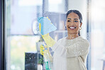 Woman, window and cleaning with water, gloves and spray at office, home or workplace. Cleaner, girl and domestic service clean glass for dirt, dust and hygiene with product, detergent and cloth