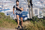 Man is running, fitness and exercise workout for cardio, health and wellness journey in nature outdoors. Young runner, determined and motivation for sports training and healthy lifestyle.