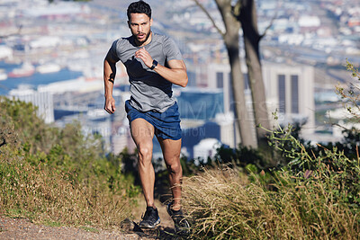 Buy stock photo Man is running, fitness and exercise workout for cardio, health and wellness journey in nature outdoors. Young runner, determined and motivation for sports training and healthy lifestyle.