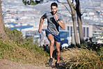 City, runner and man running in nature training, cardio exercise and endurance workout for a marathon. Sports, fitness and healthy athlete on jog on a forest or mountain trail outdoors in summer 