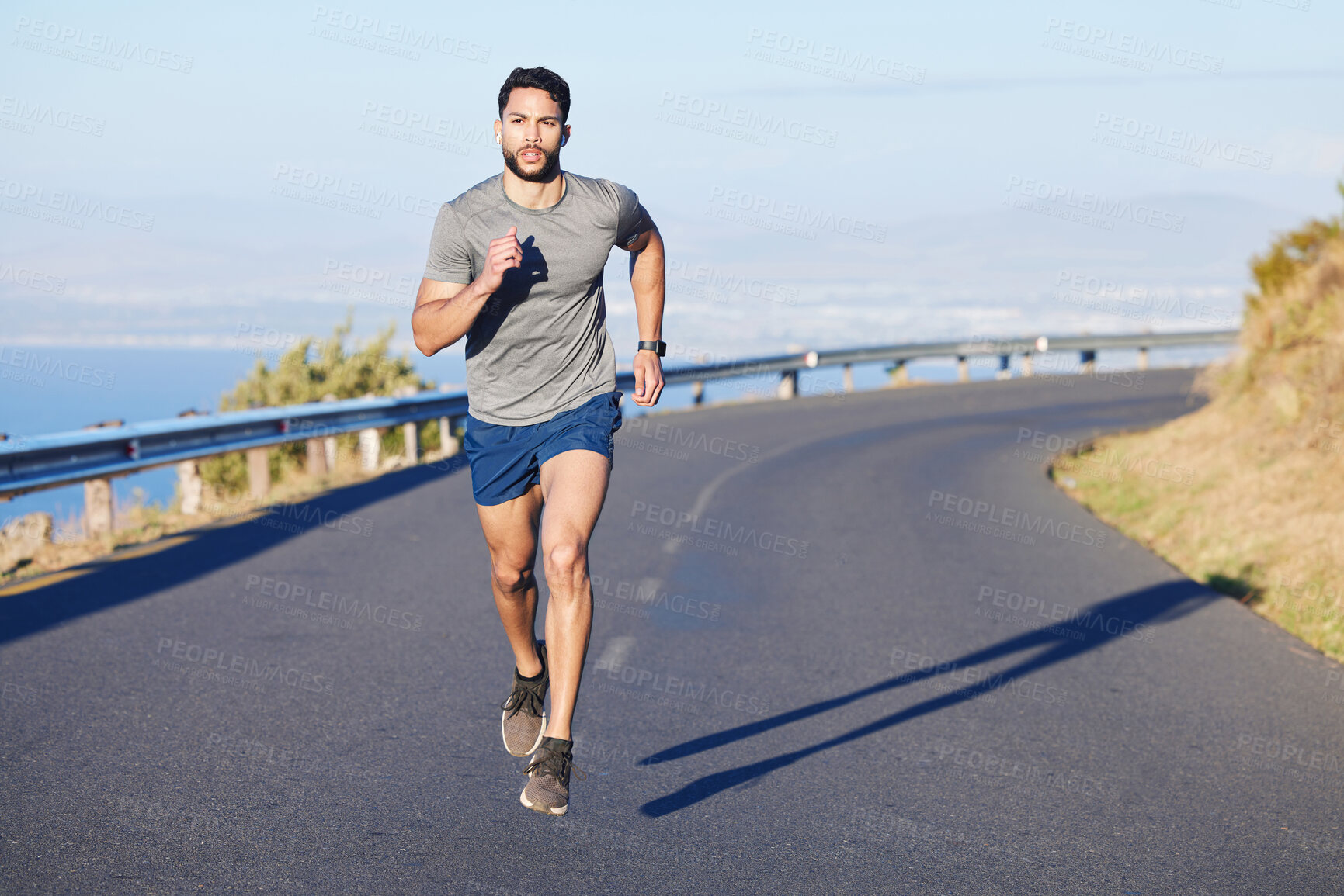 Buy stock photo Fitness, man and running on a mountain road in South Africa for healthy cardio workout in the outdoors. Active athletic male runner in sports training having a run on the street in nature