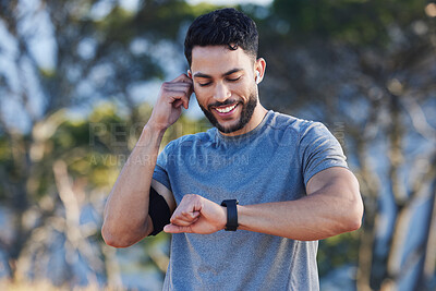 Buy stock photo Man, runner and smartwatch outdoor for workout listening to music, radio or streaming on web. Training, running and fitness for guy with tech clock to check heart, blood pressure or steps in summer