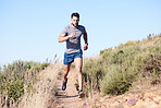 Fitness, mountain and man running in nature for exercise, cardio health and body goal. Strong athlete runner with focus during workout and training for wellness on a path in the countryside 