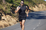 Fitness, workout and man running on road for health, exercise and sports marathon. Challenge, motivation and training with athlete runner in street for wellness, achievement and cardio in outdoor 